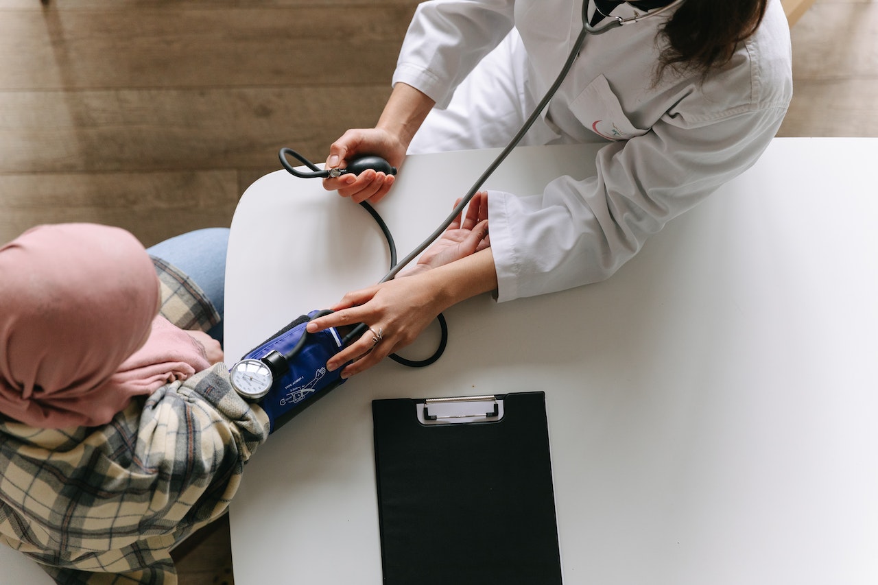 Doctor checking a patient's blood pressure during a health examination