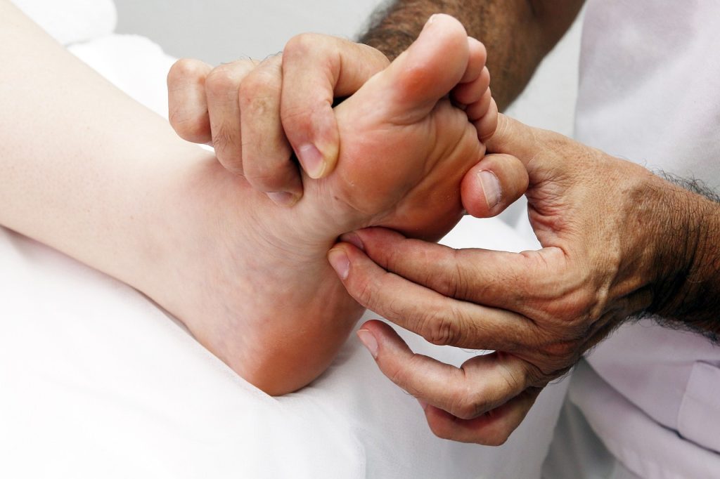 Therapist massaging a patient's foot