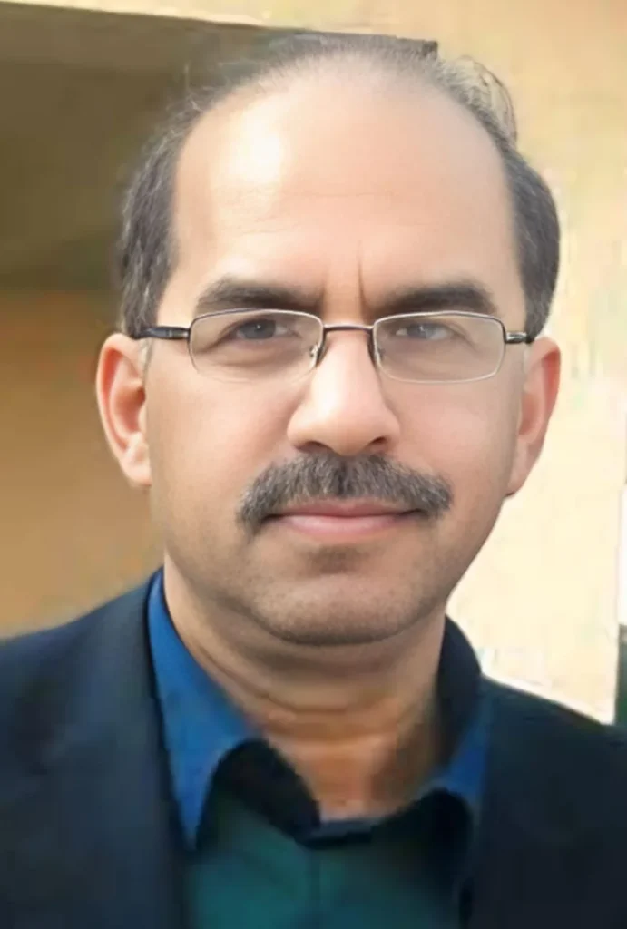 Dr. Khalid Zaman Khan, physician specializing in cardiac care at MD Health Center Lahore, wearing glasses and a navy blazer