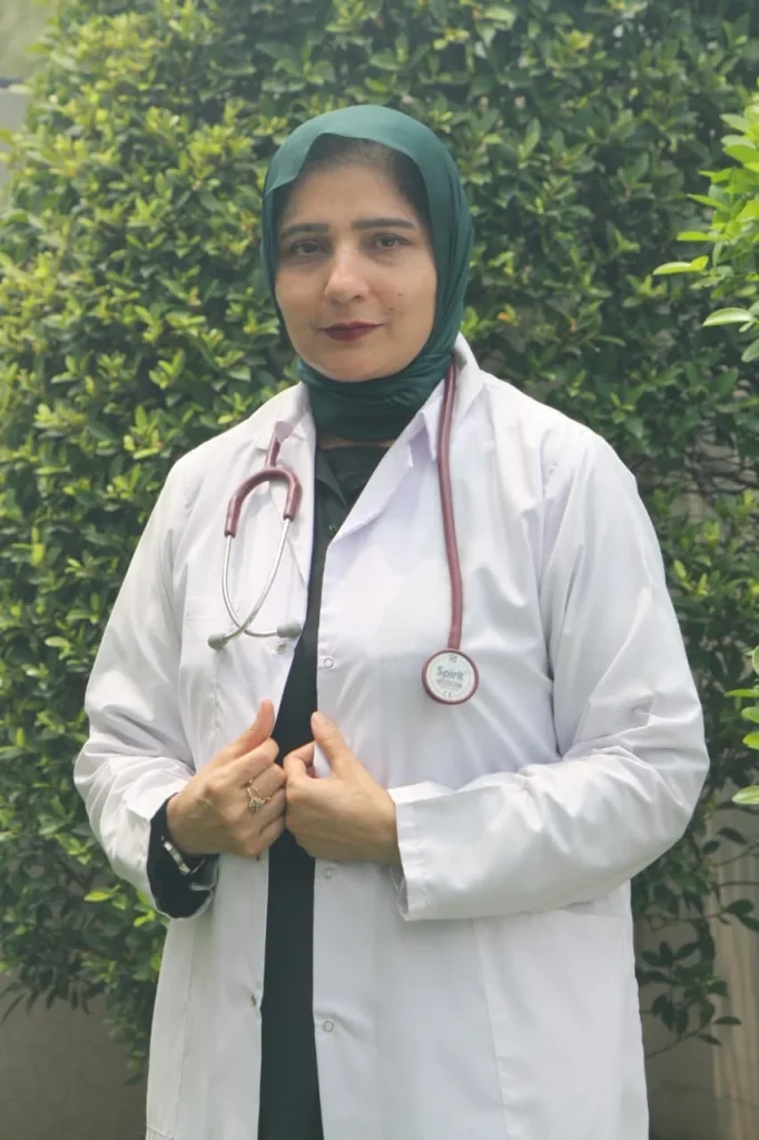 Dr. Mamoona Tahir, family medicine specialist at MD Health Center Lahore, wearing a white coat and green headscarf