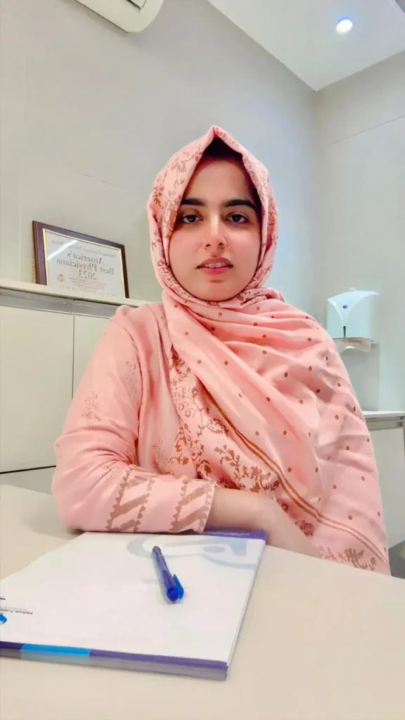 Ms. Rizwana Imdad, child and adult clinical psychologist at MD Health Center Lahore, seated in a consultation room wearing a light pink headscarf