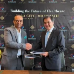 Representatives shake hands at the NOVA City and MD Health Center agreement signing